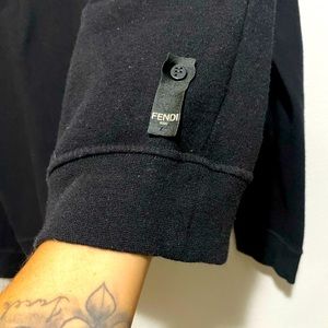 Black fendi sweater/spiked eyes on the front